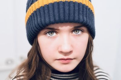 Close-up portrait of girl wearing knit hat