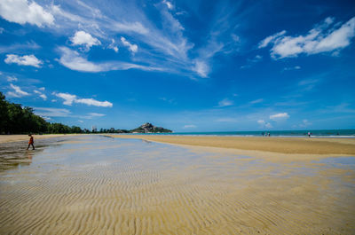 Scenic view of beach against blue sky