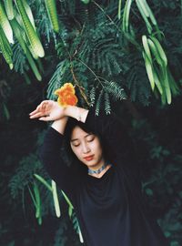 Woman holding leaves of plant