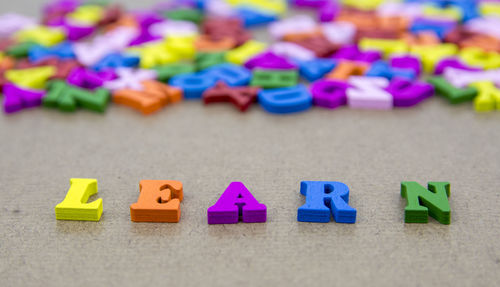 Close-up of colorful learn text on table