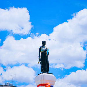 Low angle view of statue against blue sky