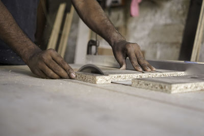 Closeup shot of circular saw , a carpenter cutting a plywood. manufacture of wooden furniture. 