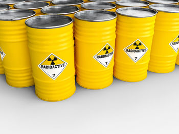 Yellow radioactive containers over white background