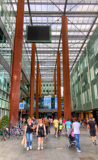 Group of people walking on building in city