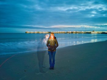 Multiple image of woman standing at beach against cloudy sky