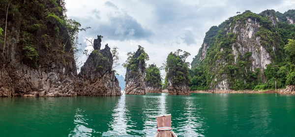 Scenic landscape of boat view in the big river and reservoir dam with mountain and nature forest