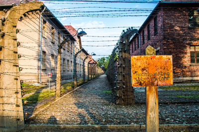 Road sign on wall of old building