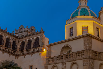 Low angle view of building against clear blue sky