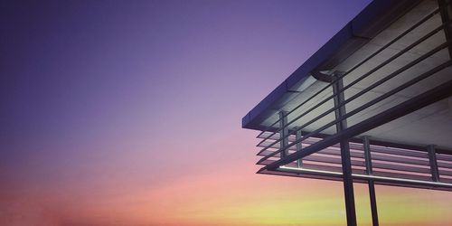 Low angle view of building against clear sky at sunset