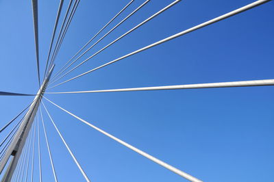 Low angle view of cables against blue sky