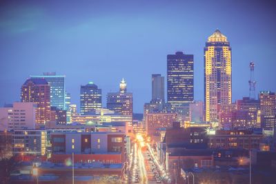 Illuminated buildings against sky at night