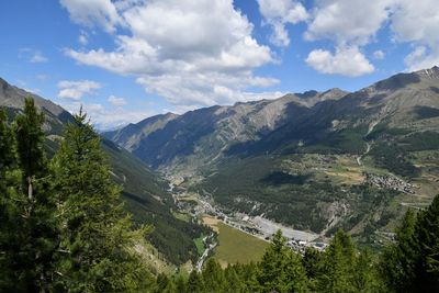 Scenic view of valley and mountains against sky