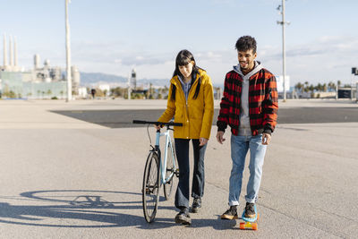 Portrait of young man riding bicycle on road