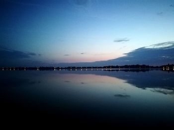 Scenic view of lake against sky at sunset