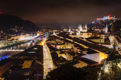 High angle view of illuminated buildings in city at night