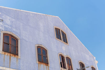 Low angle view of building against clear blue sky