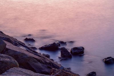 High angle view of rocks in sea against sky