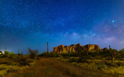 Scenic view of rock formation against sky at night