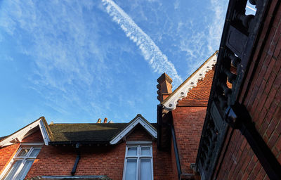 Low angle view of brick buildings against sky