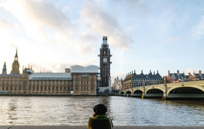 Rear view of woman on bridge over river