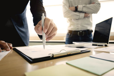 Close-up of people working on table