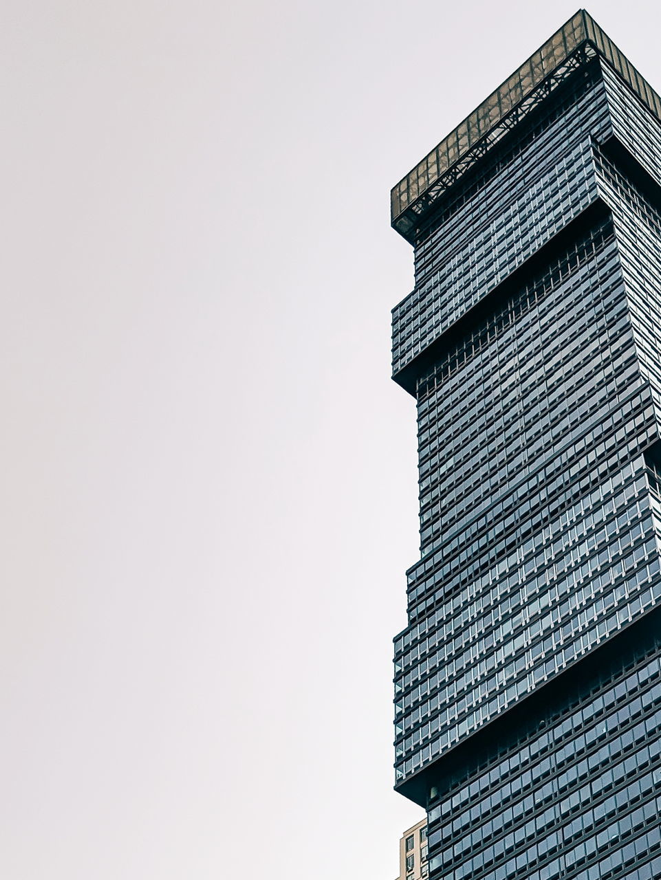 building exterior, built structure, architecture, sky, low angle view, building, copy space, no people, clear sky, nature, city, day, office, outdoors, office building exterior, tall - high, stack, high section, close-up, window, skyscraper