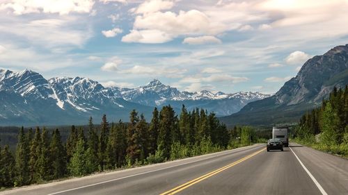 Road amidst mountains against sky