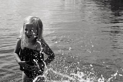 Girl splashing water in sea