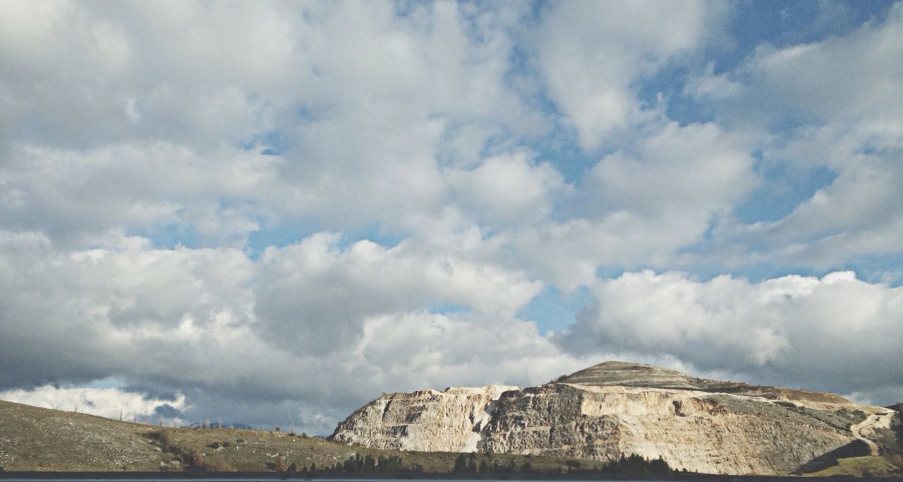 sky, cloud - sky, cloudy, built structure, architecture, low angle view, building exterior, cloud, history, day, nature, tranquility, rock - object, scenics, outdoors, stone wall, old ruin, no people, beauty in nature, tranquil scene