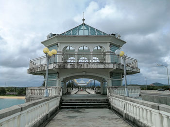 View of bridge over water against cloudy sky