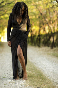 Full length of woman standing on dirt road