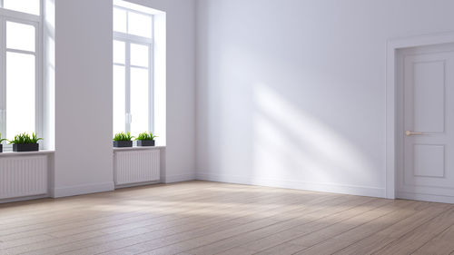 View of white window on hardwood floor against wall