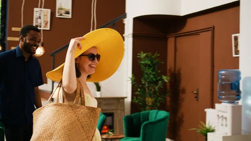 Rear view of woman wearing hat at home