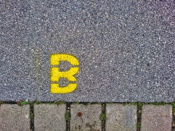 Close-up of yellow text on road