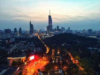 High angle view of illuminated city buildings against sky