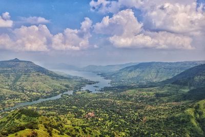 High angle view of green mountains against sky