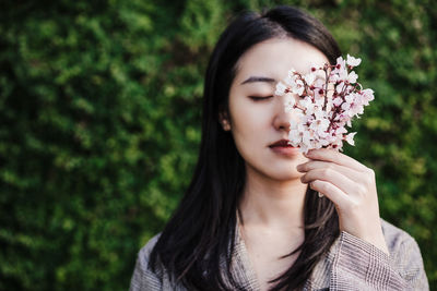 Young woman holding flower