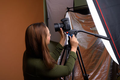 Portrait of woman holding camera