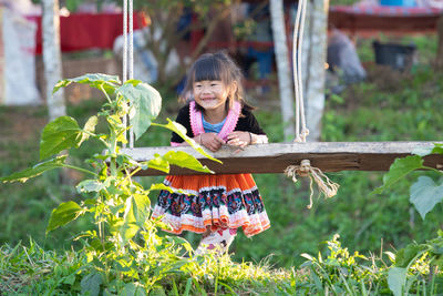 Portrait of smiling girl holding plants