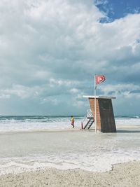 Man on beach against sky