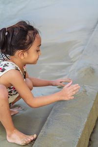 Cute little girl playing in the sand