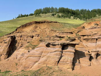 Rock formation on landscape against sky. uneven rough wall of red rock, red canyon in kukmor, russia