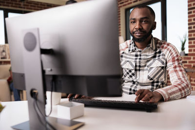 Portrait of young man working at table