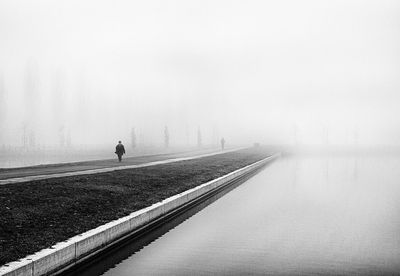 Man in foggy weather against sky