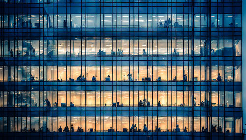 People work at office. buildings windows with employees working inside. business, corporate concept.