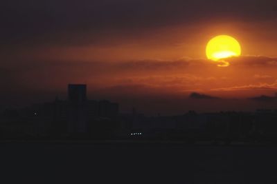 Silhouette of city at sunset