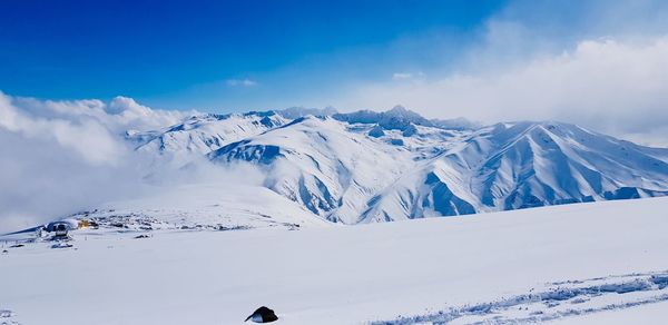 Scenic view of snow covered mountains against sky