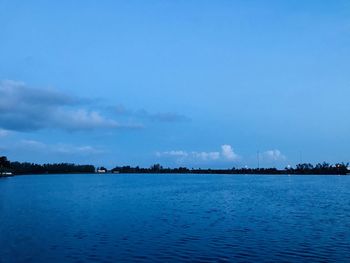 Scenic view of lake against blue sky