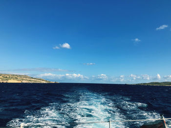 Scenic view of sea against blue sky