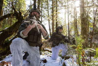 Panoramic shot of man holding umbrella in forest